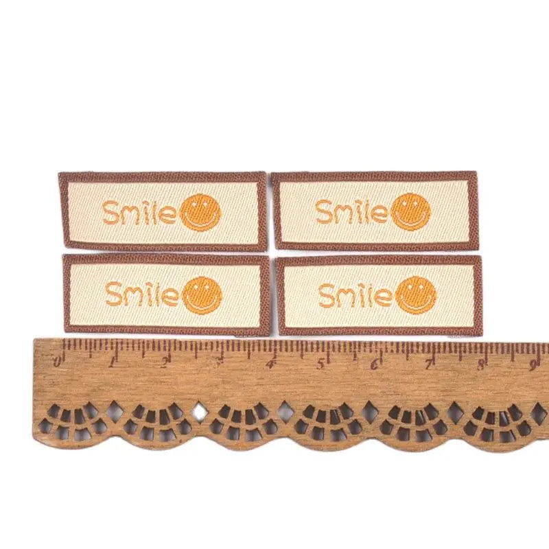 50Pcs/Lot Cartoon Embroidery Washable Care Labels For Clothing Sewing Accessories Bags Smlie Face Tags Garment DIY Crafts c3207 Qme