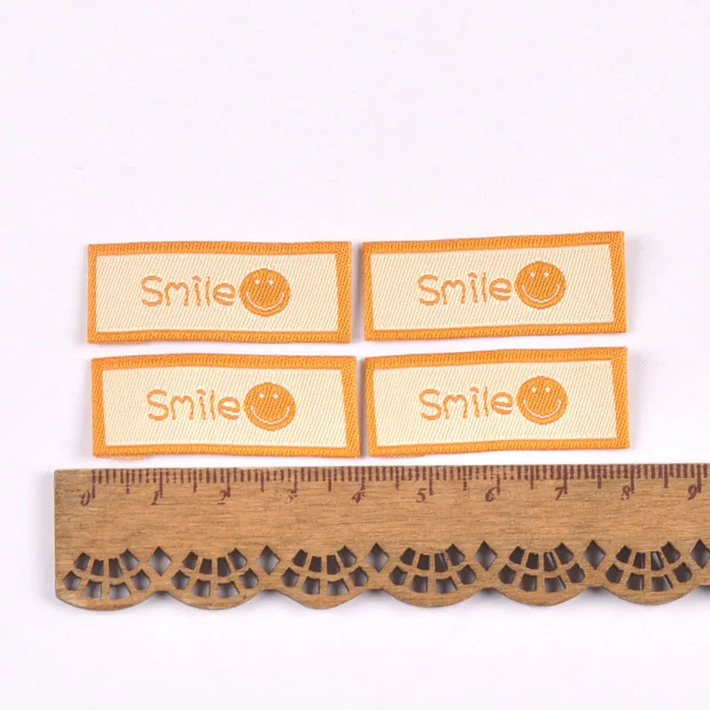 50Pcs/Lot Cartoon Embroidery Washable Care Labels For Clothing Sewing Accessories Bags Smlie Face Tags Garment DIY Crafts c3207 Qme 1