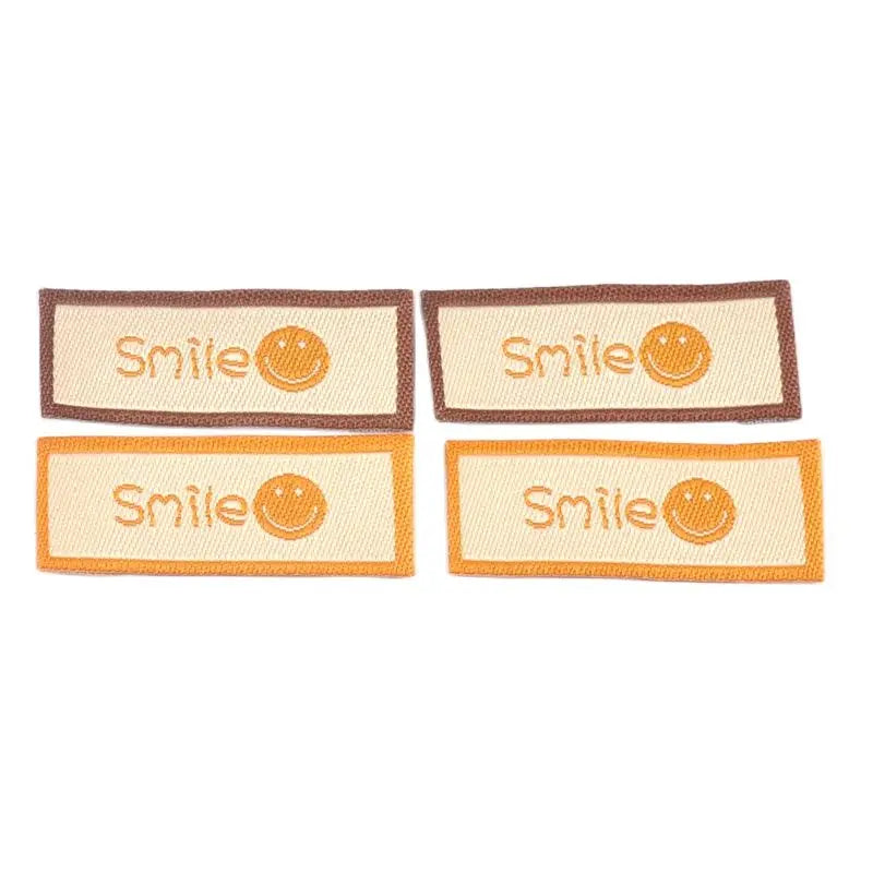 50Pcs/Lot Cartoon Embroidery Washable Care Labels For Clothing Sewing Accessories Bags Smlie Face Tags Garment DIY Crafts c3207 Qme