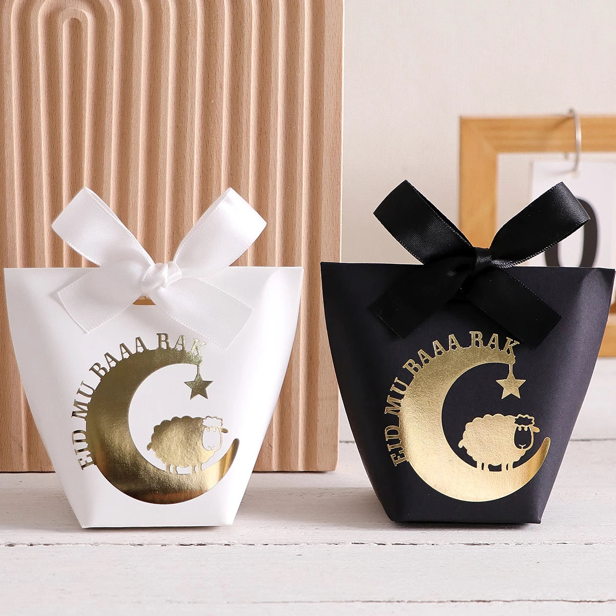 10 Elegant Black, White, and Green Eid Al-Adha Gift Boxes, Decorated with Creative Golden Crescent Lanterns and Lamb Motifs Perfect for Holding Candies, Chocolates, and Small Gifts. It Is a Celebration of the Eid Al-Adha. Qme