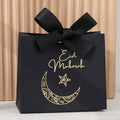 5 Exquisite and Compact Eid Gift Boxes, Available in Elegant Black, Luxurious Green, and Pure White, Decorated with Delicate Gold and Silver Star and Moon Patterns, and Adorned with Luxurious Gold and Silver Ribbons. These Gi Qme 5Pcs--Black- 11.5X10X4.5Cm