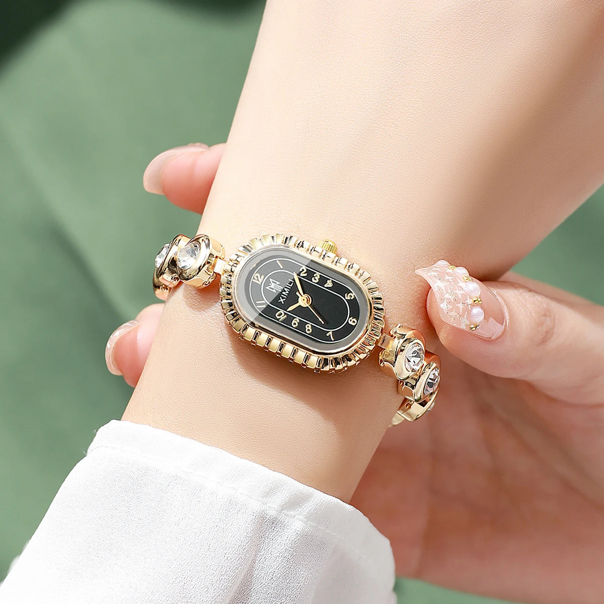 Women's Luxury Crystal Quartz Watch, Oval Black Dial with Diamond Bezel and Gold Tone Band, Casual/Office Wear Qme