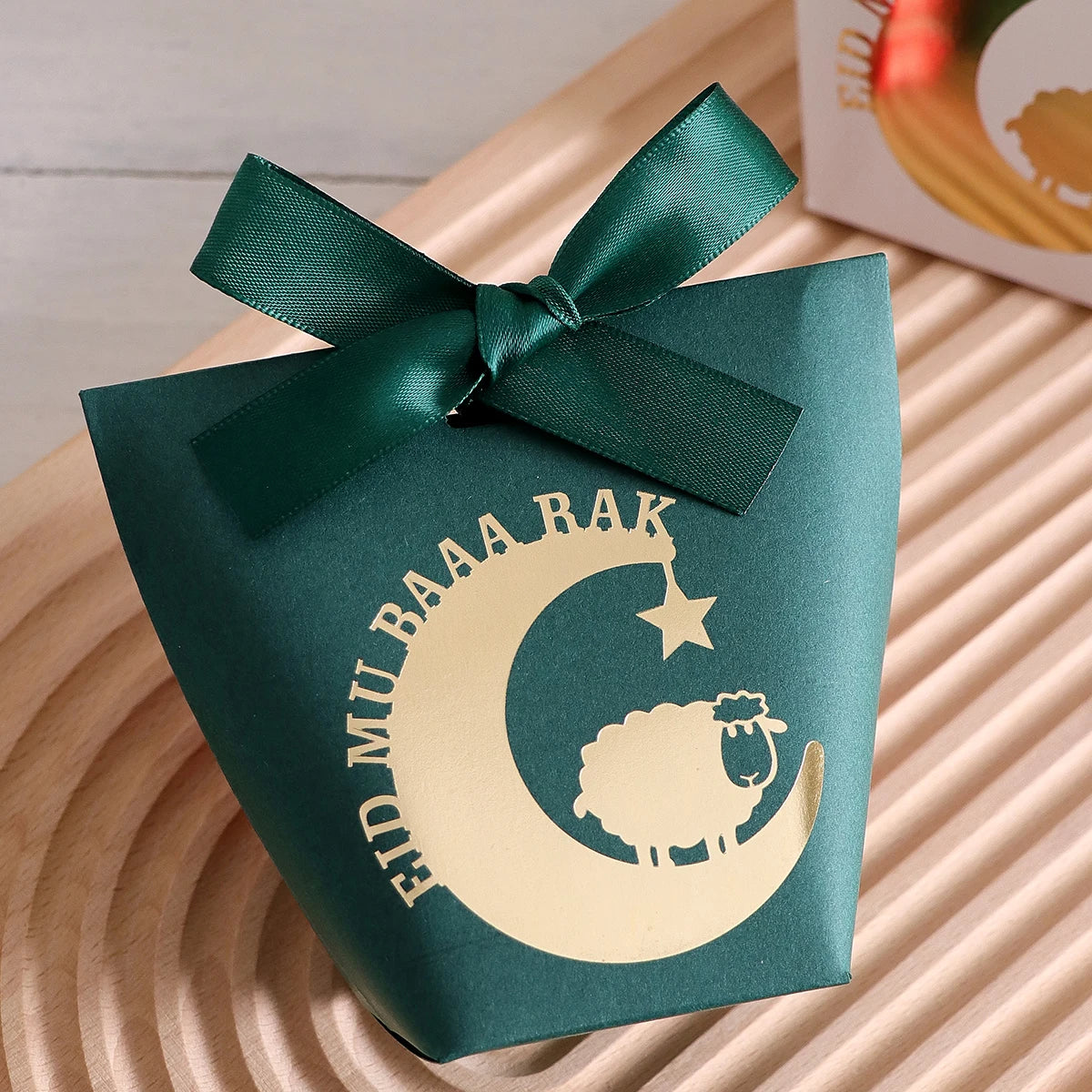 10 Elegant Black, White, and Green Eid Al-Adha Gift Boxes, Decorated with Creative Golden Crescent Lanterns and Lamb Motifs Perfect for Holding Candies, Chocolates, and Small Gifts. It Is a Celebration of the Eid Al-Adha. Qme