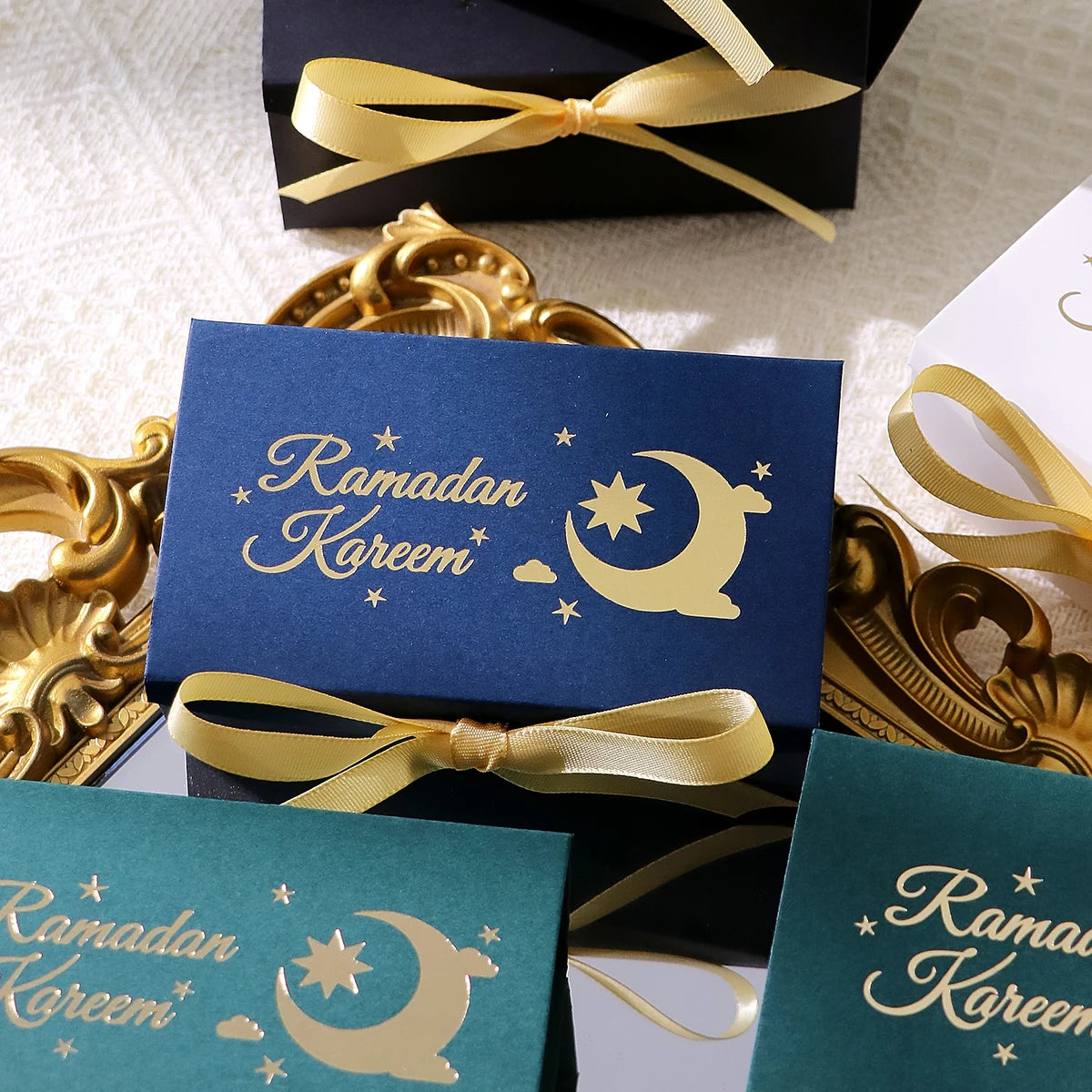 10 Rectangular Multi-Colored Gift Boxes with Gold Crescent and Planet Designs Printed on Them, Specifically Designed for Ramadan, and Adorned with Gold Ribbons — Perfect for Packaging Homemade Sweets, Premium Dates, and Sma Qme