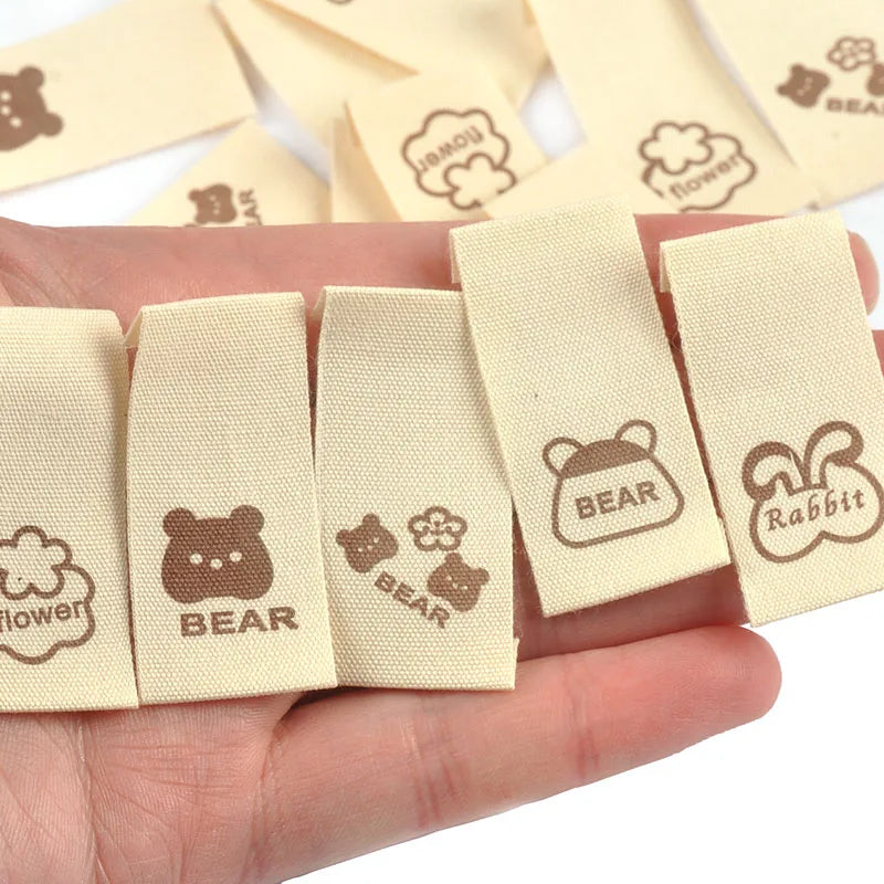50pcs/lot 20x40mm Lovely Bear/Flower/Rabbit Printed Beige Label For DIY Decor Clothing Sewing Accessories Handmade Crafts c4146 Qme
