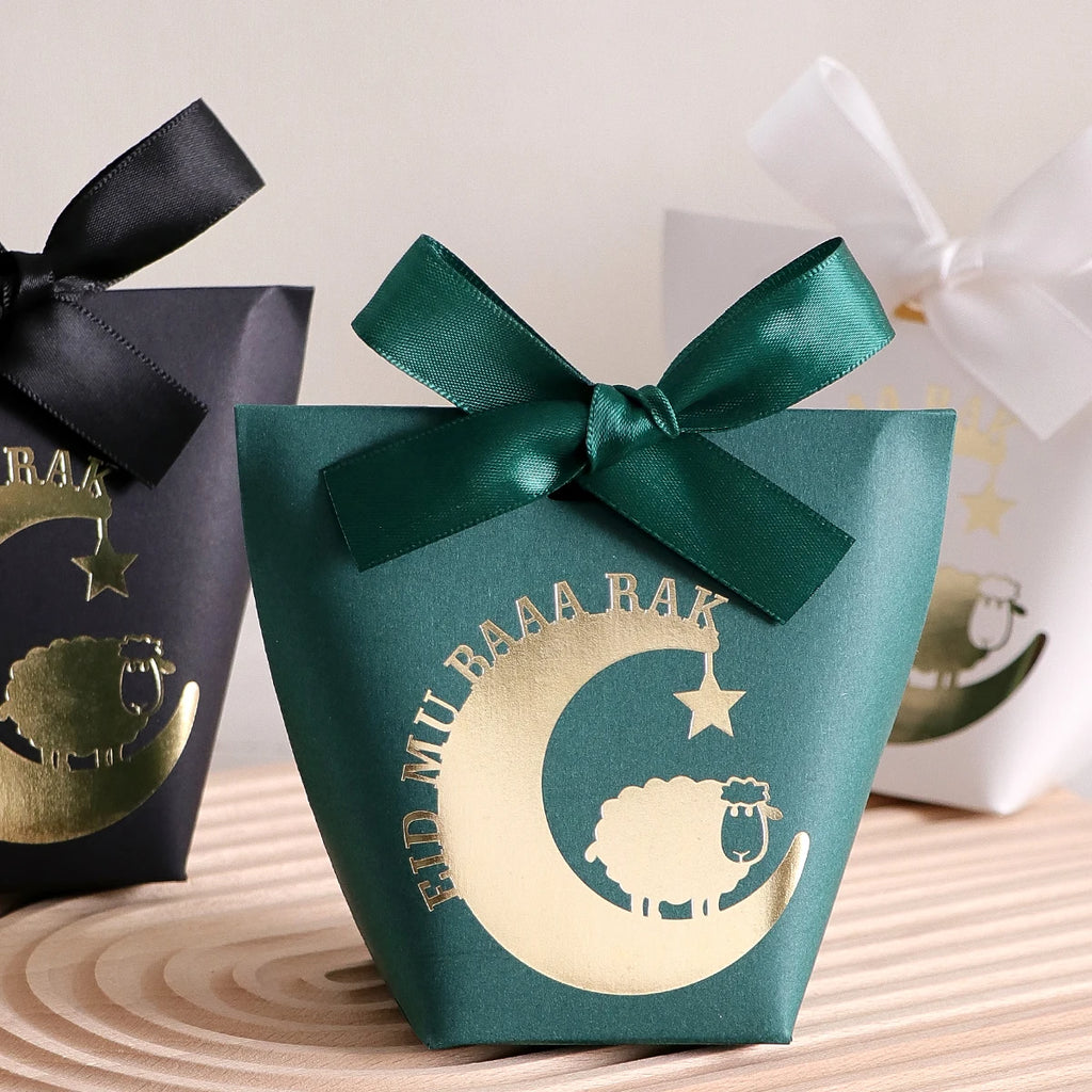 10 Elegant Black, White, and Green Eid Al-Adha Gift Boxes, Decorated with Creative Golden Crescent Lanterns and Lamb Motifs Perfect for Holding Candies, Chocolates, and Small Gifts. It Is a Celebration of the Eid Al-Adha. Qme