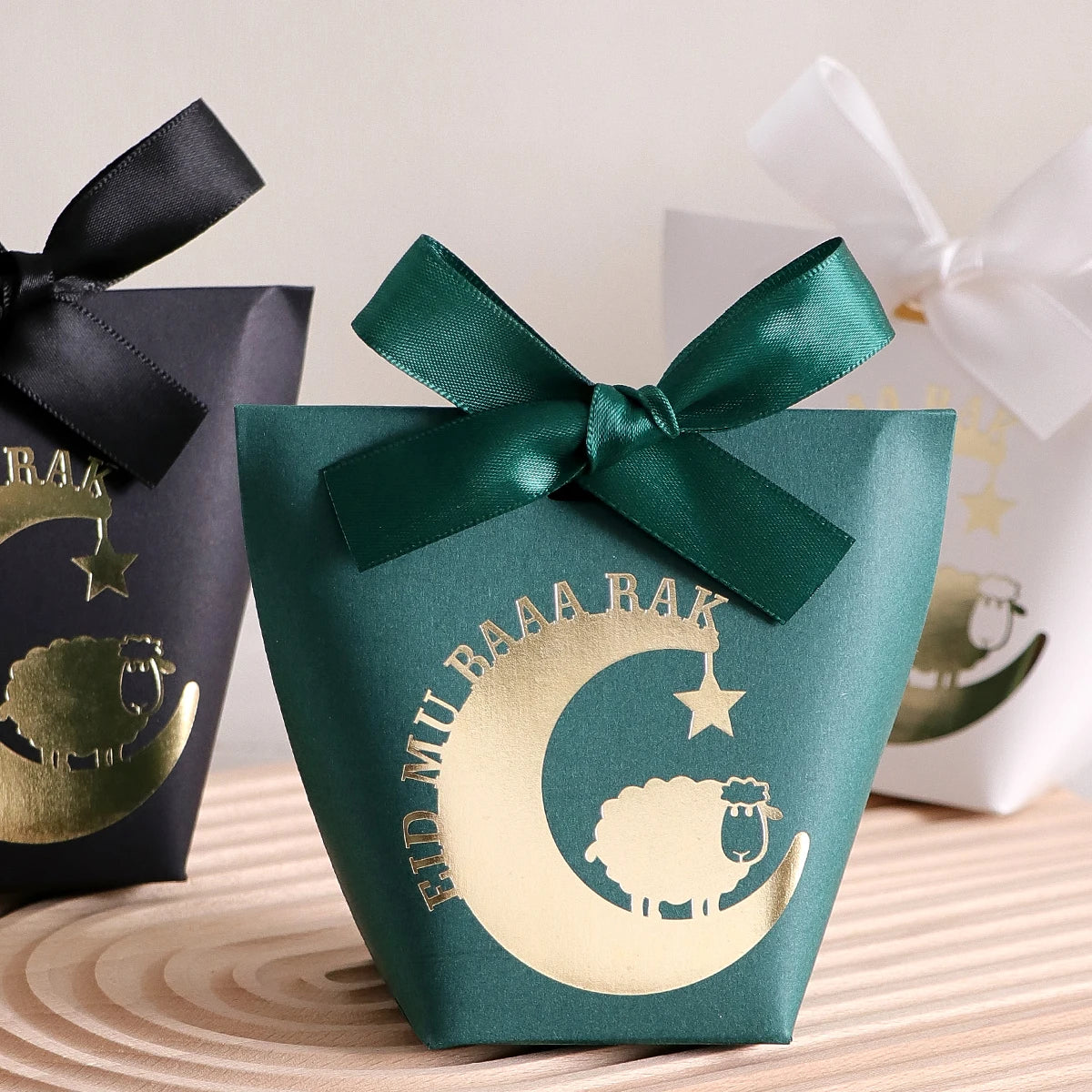 10 Elegant Black, White, and Green Eid Al-Adha Gift Boxes, Decorated with Creative Golden Crescent Lanterns and Lamb Motifs Perfect for Holding Candies, Chocolates, and Small Gifts. It Is a Celebration of the Eid Al-Adha. Qme